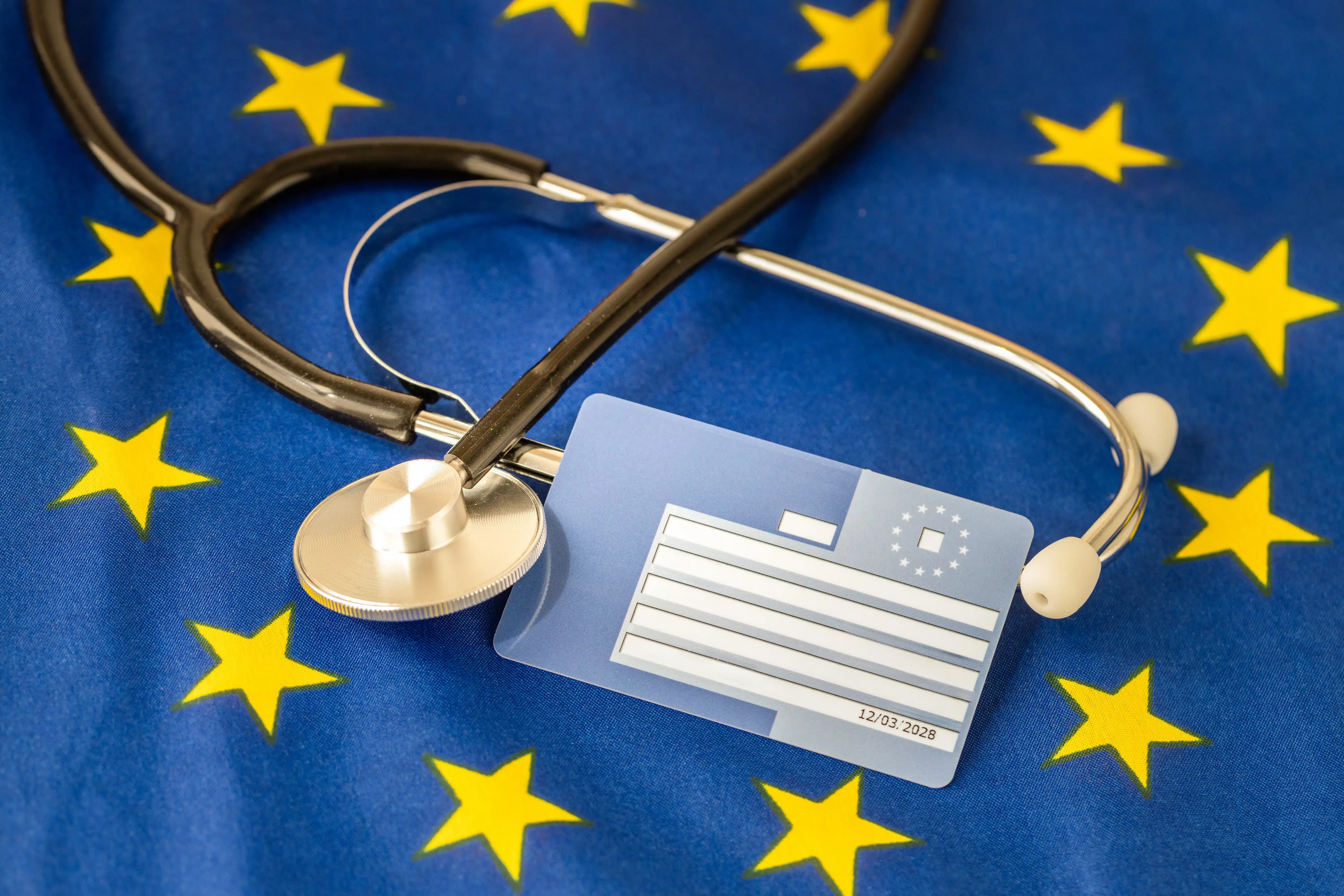 European Health Insurance Card with a stethoscope placed on an EU flag